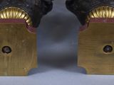 pair of black and gold figurines of a man and a woman