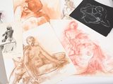 a lot of drawings on a table with a pair of scissors
