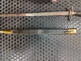 two knives that are laying on a metal surface