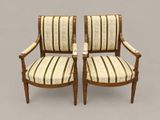 pair of antique chairs with striped upholstered arms and arms