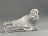 clear glass figurine of a bird on a clear base
