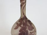a purple vase that is sitting on a white surface