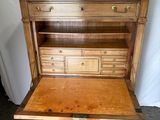 a wooden desk with a drawer on top of it