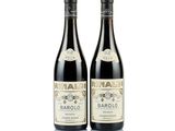 two bottles of wine sitting next to each other on a white surface