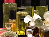 several bottles of perfume are lined up on a black surface