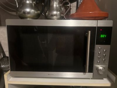 un micro-ondes posé sur une étagère dans la cuisine