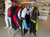 a lot of clothes hanging on a rack in a store