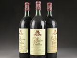 three bottles of wine sitting on top of a table next to each other