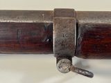 an old gun with a wooden barrel and a metal handle