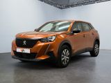 the orange car is parked in a large room with white walls