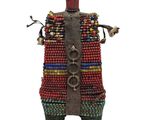 a close up of a doll made out of beads on a white background