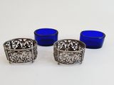 three blue glass cups sitting on top of a table next to each other