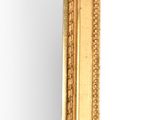 mirror with a gold frame and a decorative pattern on the edge
