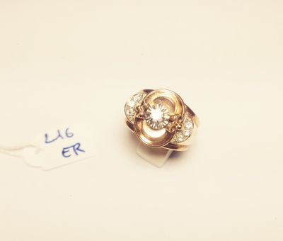 a gold ring with a diamond on it on a piece of paper
