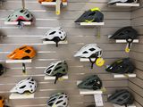 many helmets displayed on the wall in the store