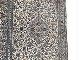 an antique persian rug with a blue border and floral design