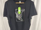 a black t shirt with a bird on it hanging on a hanger