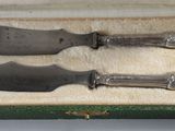 two knives in a box on a table