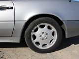 a silver car that is parked on the side of the road