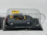 a black toy car in a clear plastic case