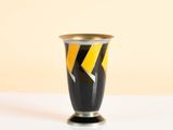 a black vase with a yellow and black design on it