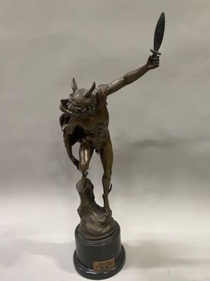bronze statue of a man holding a knife and a knife in his hand