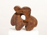 sculptures made of wood sit on a white pedestal against a white background