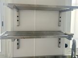 a picture of a stainless steel shelf above a kitchen sink