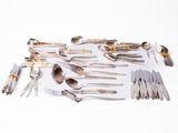a lot of silver spoons and forks on the table