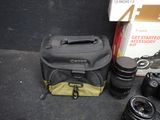 a camera and a camera bag sitting on the ground