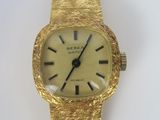 an image of a close up of a wrist watch on a white surface