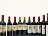 several bottles of wine are lined up in a row on a white surface