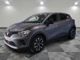 Une voiture grise est garée sur un sol à damier dans un showroom