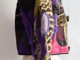 jacket on a mannequin head with a colorful jacket on it