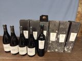 several bottles of wine are lined up in a row on a table
