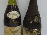 two bottles of wine sitting next to each other on a table