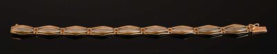 a close up of a gold bracelet on a black surface