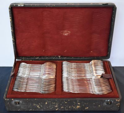 silverware in a case on a table with a black table cloth