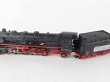 a toy train on a white surface with a white background