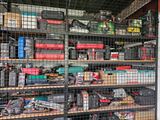 many different types of tools on the shelves in the garage