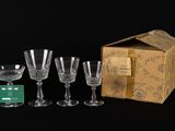 several wine glasses and a box of wine glasses on a black surface