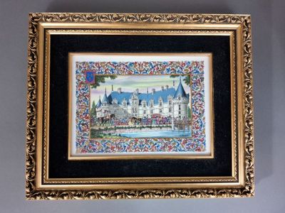 painting of a castle in a gold frame hanging on a wall