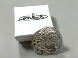 a silver ring sitting on top of a white box