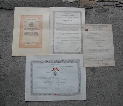 several papers are laying on the ground next to a stone wall