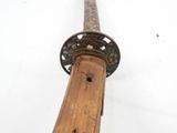 a close up view of a sword with a wooden handle