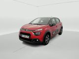a red citrole is parked in a white room