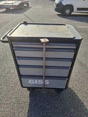 a metal cart that is sitting in the parking lot