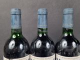 three bottles of wine that are sitting on a table