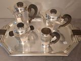 a silver tray with a silver tea set on it
