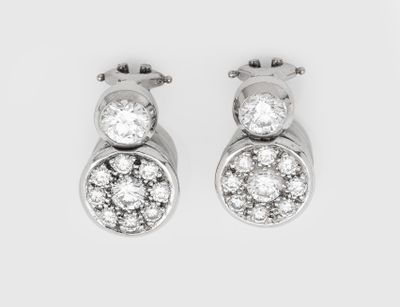 a pair of diamond earrings on a white background